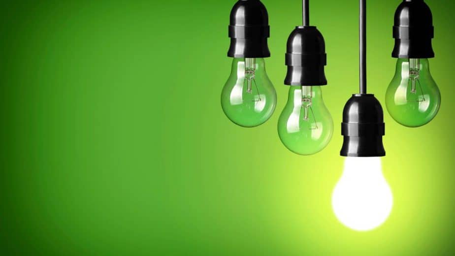 green background with 4 light bulbs hanging down, one of them is lit up